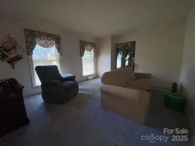 a living room with furniture and a lamp