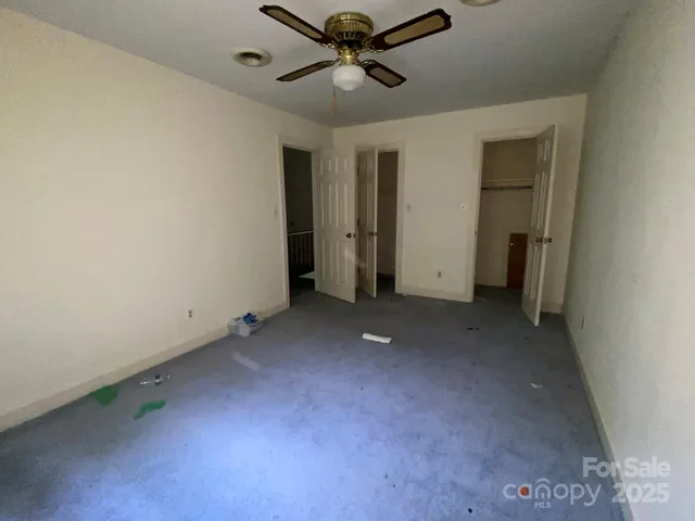 a view of a livingroom with a ceiling fan and window