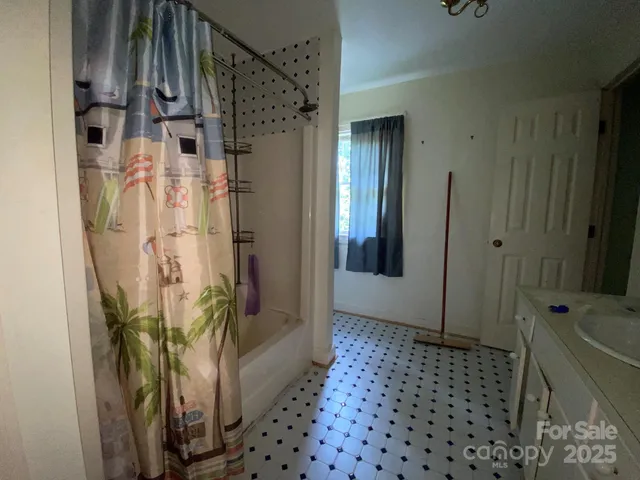 a bathroom with a bathtub and shower