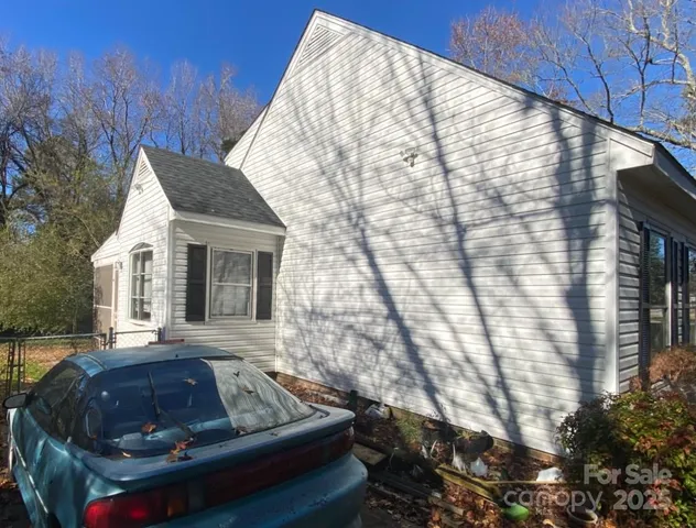 a front view of a house with a yard and potted plants