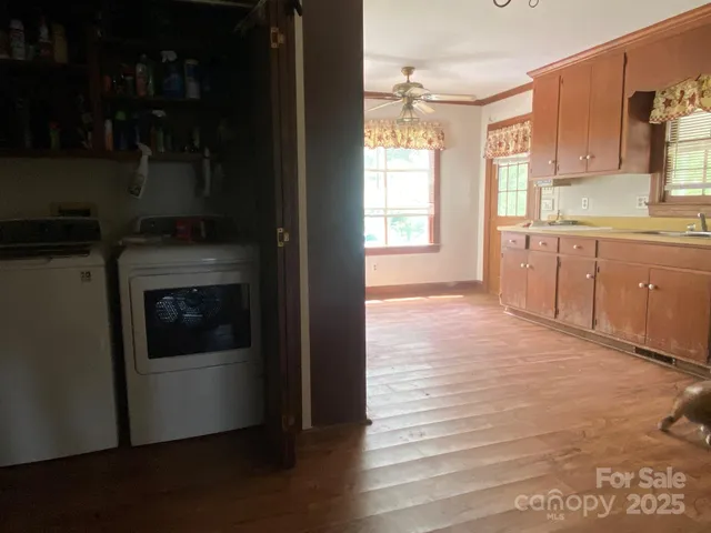 a kitchen with granite countertop a refrigerator stove and sink