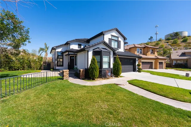 a front view of a house with a yard table and chairs
