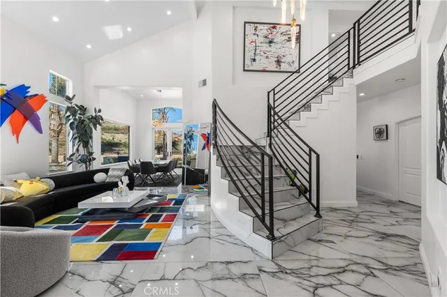 a living room with lots of furniture and paintings on the wall