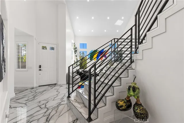 a living room with patio furniture and a rug