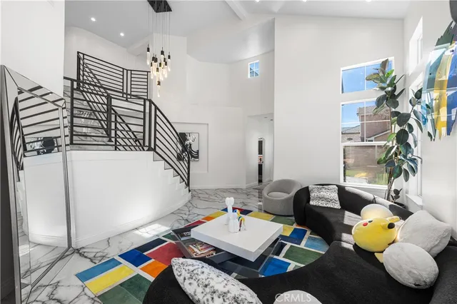 a dining room with furniture a chandelier and wooden floor