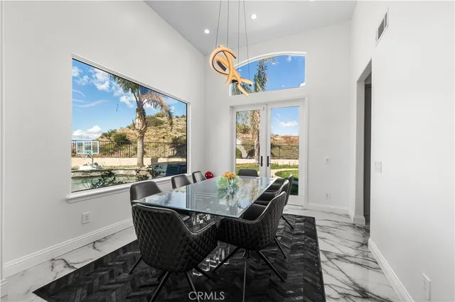 a dining room with furniture a rug and wooden floor