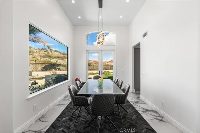 a view of a dining room with furniture wooden floor and a chandelier