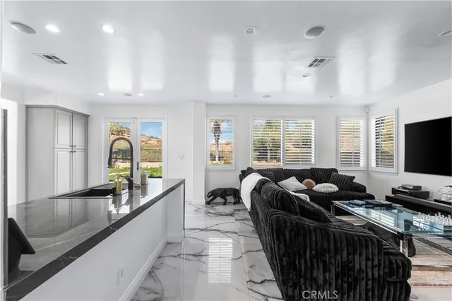 a bedroom with furniture and a flat screen tv
