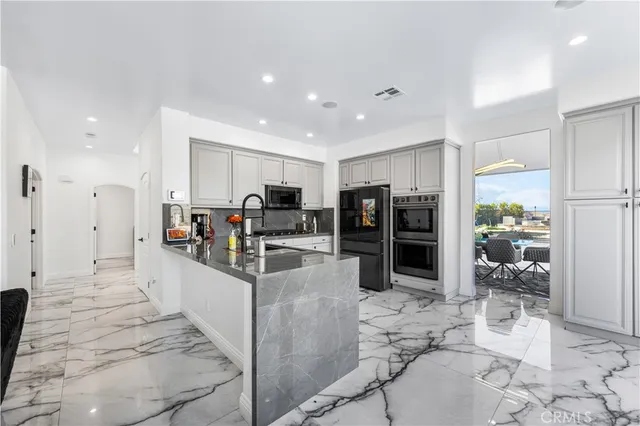a kitchen with sink cabinets and stainless steel appliances