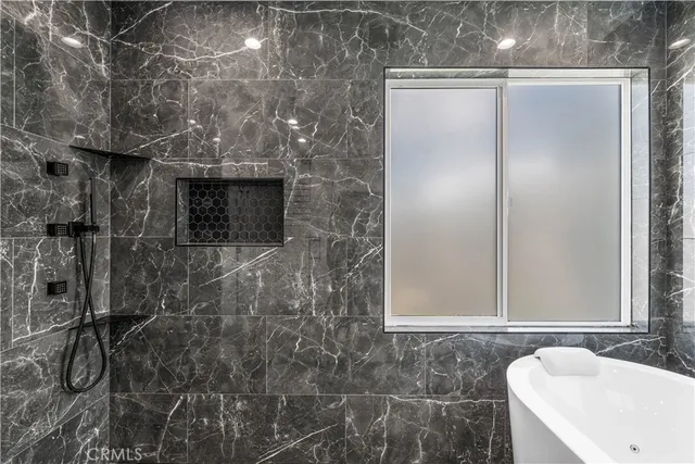 a bathroom with a sink a mirror and a bathtub