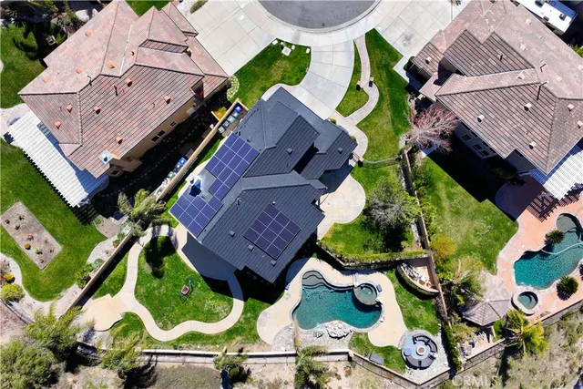 an aerial view of a house with a garden and swimming pool