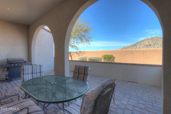 a balcony with table and chairs