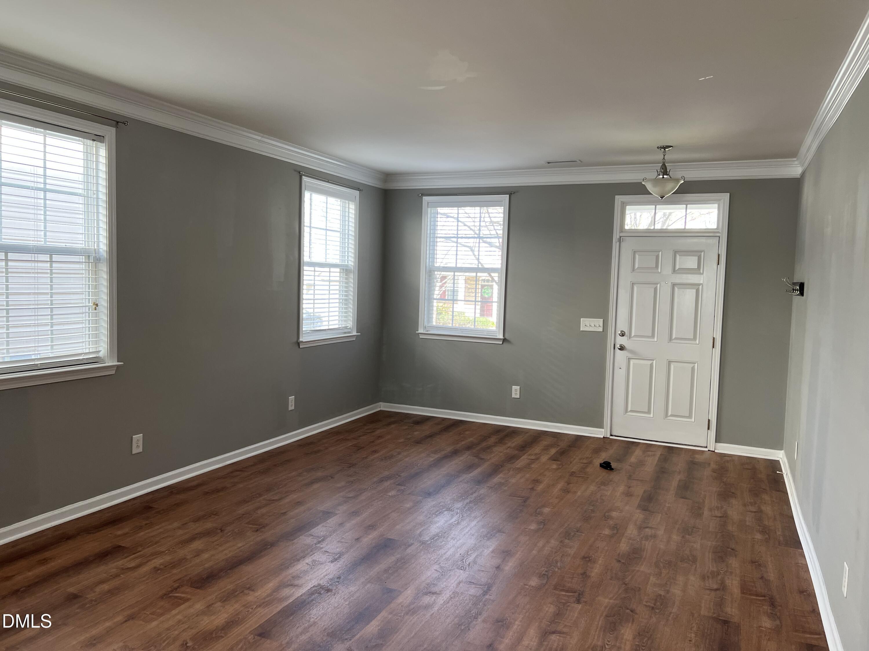 527 Emerald Downs Road Cary, NC 27519 - Photo 2 of 12 an empty room with wooden floor and windows
