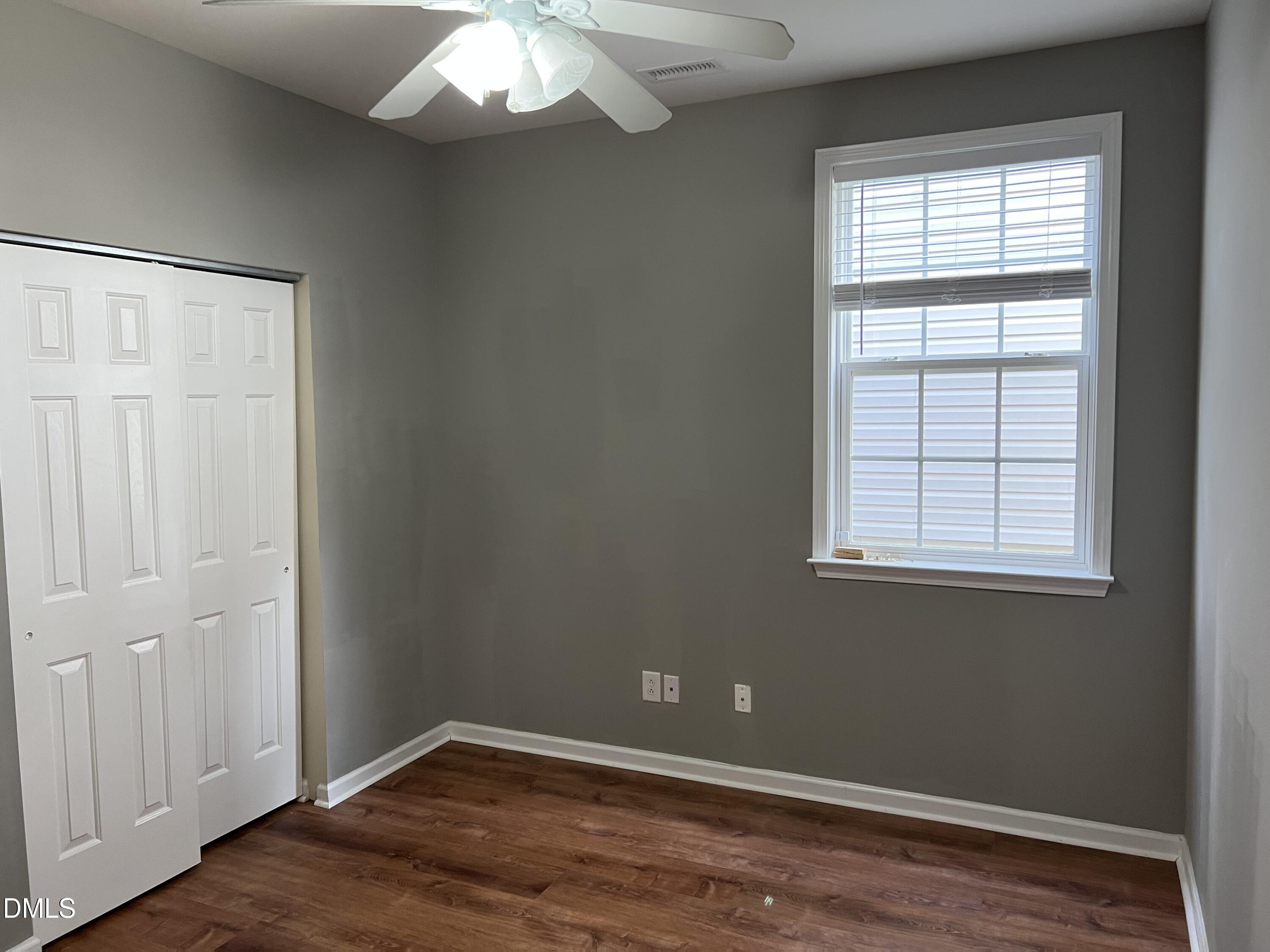 527 Emerald Downs Road Cary, NC 27519 - Photo 7 of 12 an empty room with wooden floor and windows