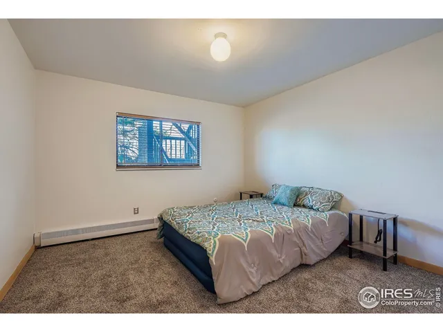 a bedroom with a bed and a desk