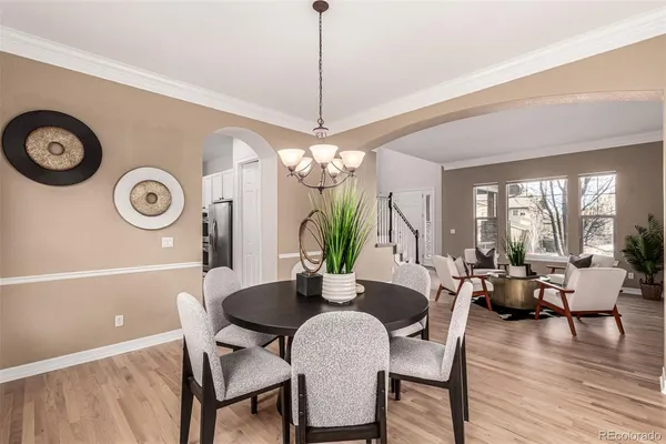 a dining room with furniture and wooden floor