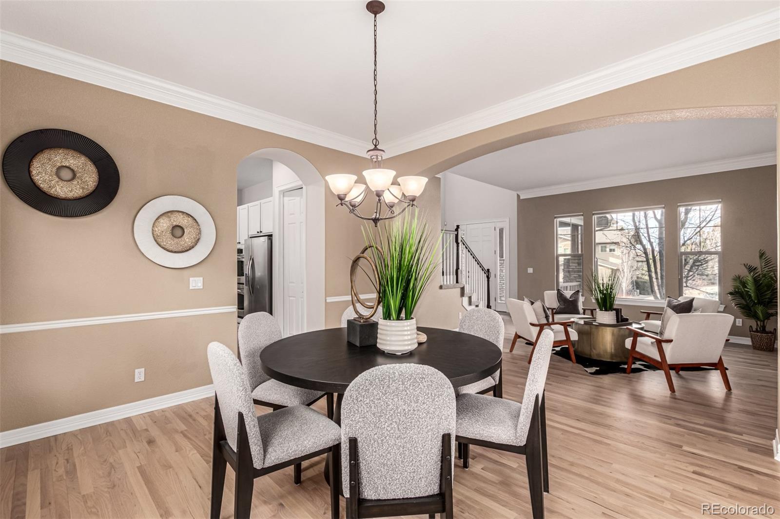 20166 East Shady Ridge Road Parker, CO 80134 - Photo 12 of 50 a dining room with furniture a chandelier and wooden floor