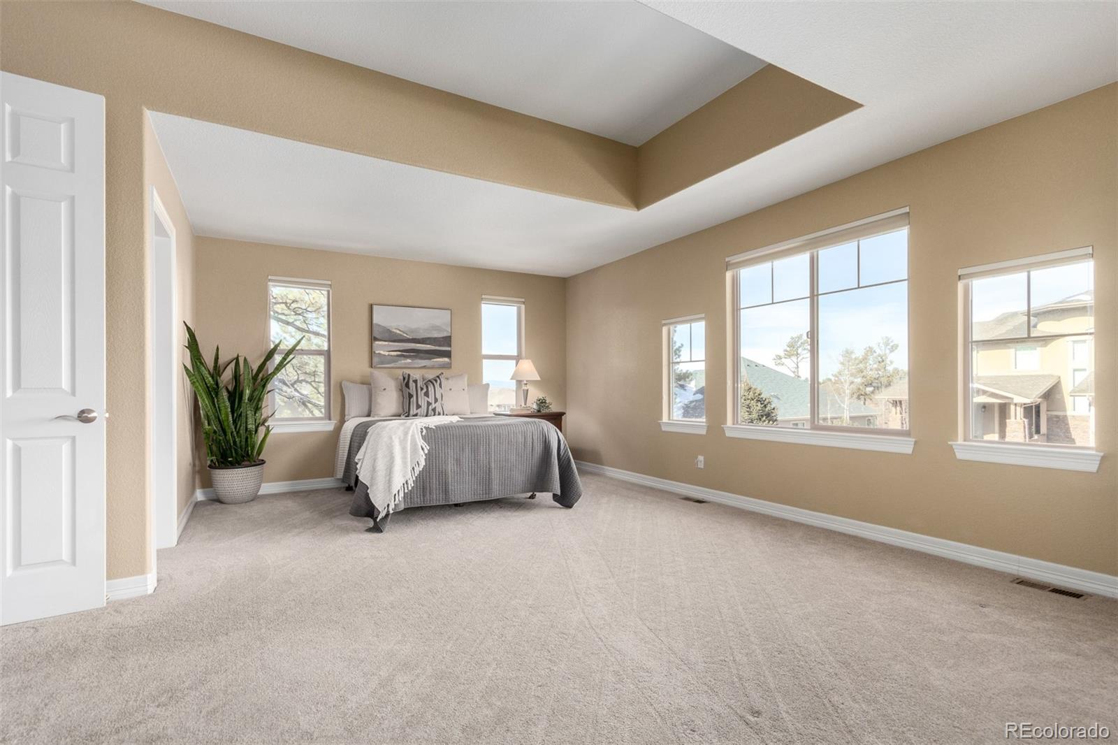20166 East Shady Ridge Road Parker, CO 80134 - Photo 21 of 50 a bedroom with a large bed and a window