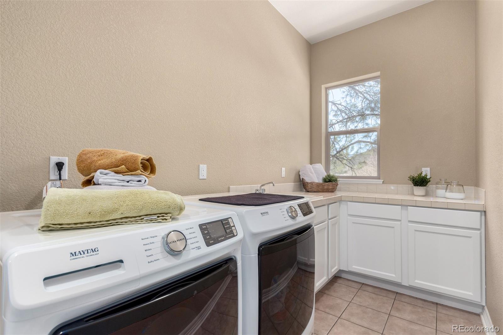 20166 East Shady Ridge Road Parker, CO 80134 - Photo 24 of 50 a kitchen with a stove and cabinets