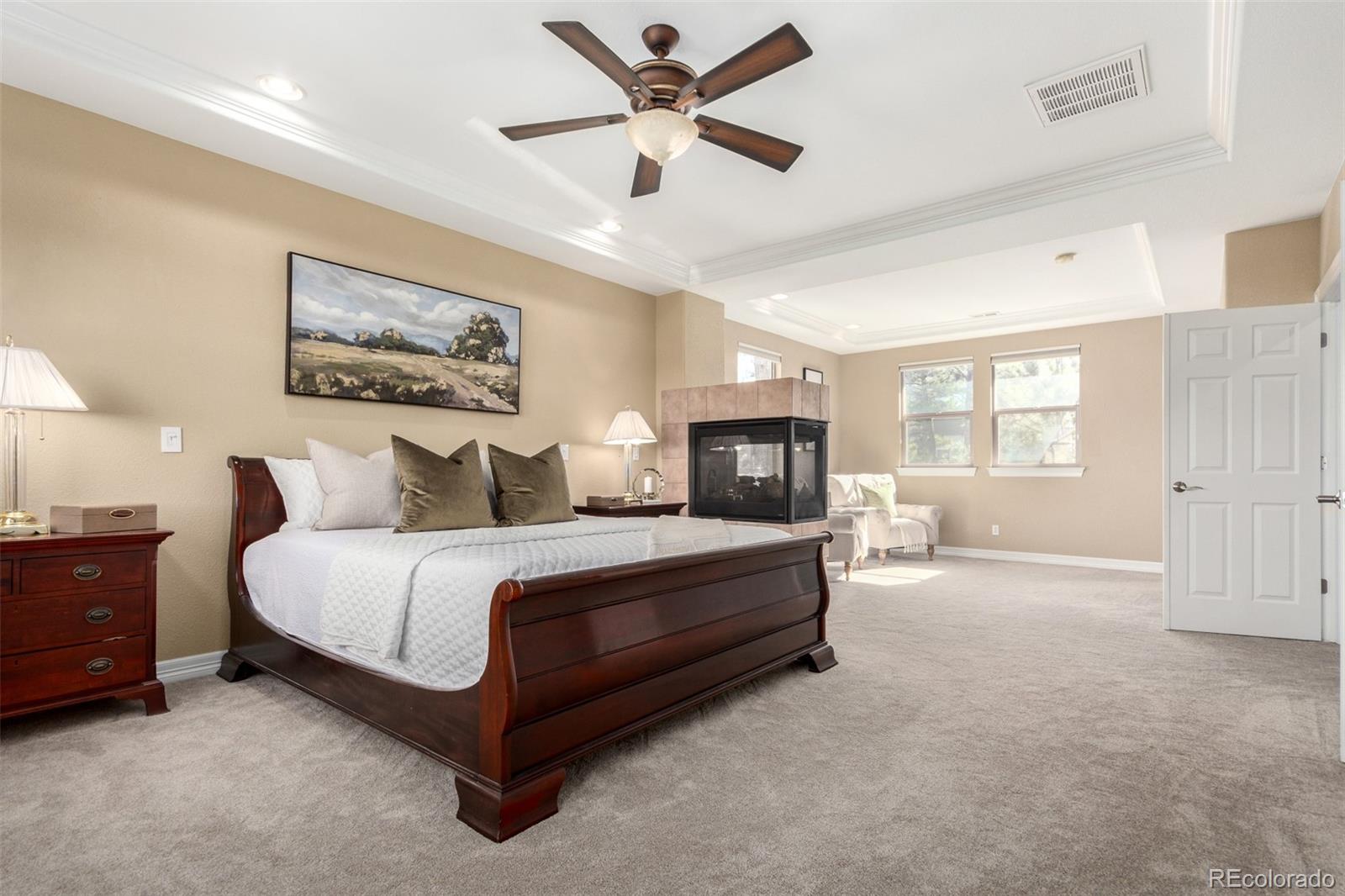 20166 East Shady Ridge Road Parker, CO 80134 - Photo 25 of 50 a spacious bedroom with a bed painting on wall and a window