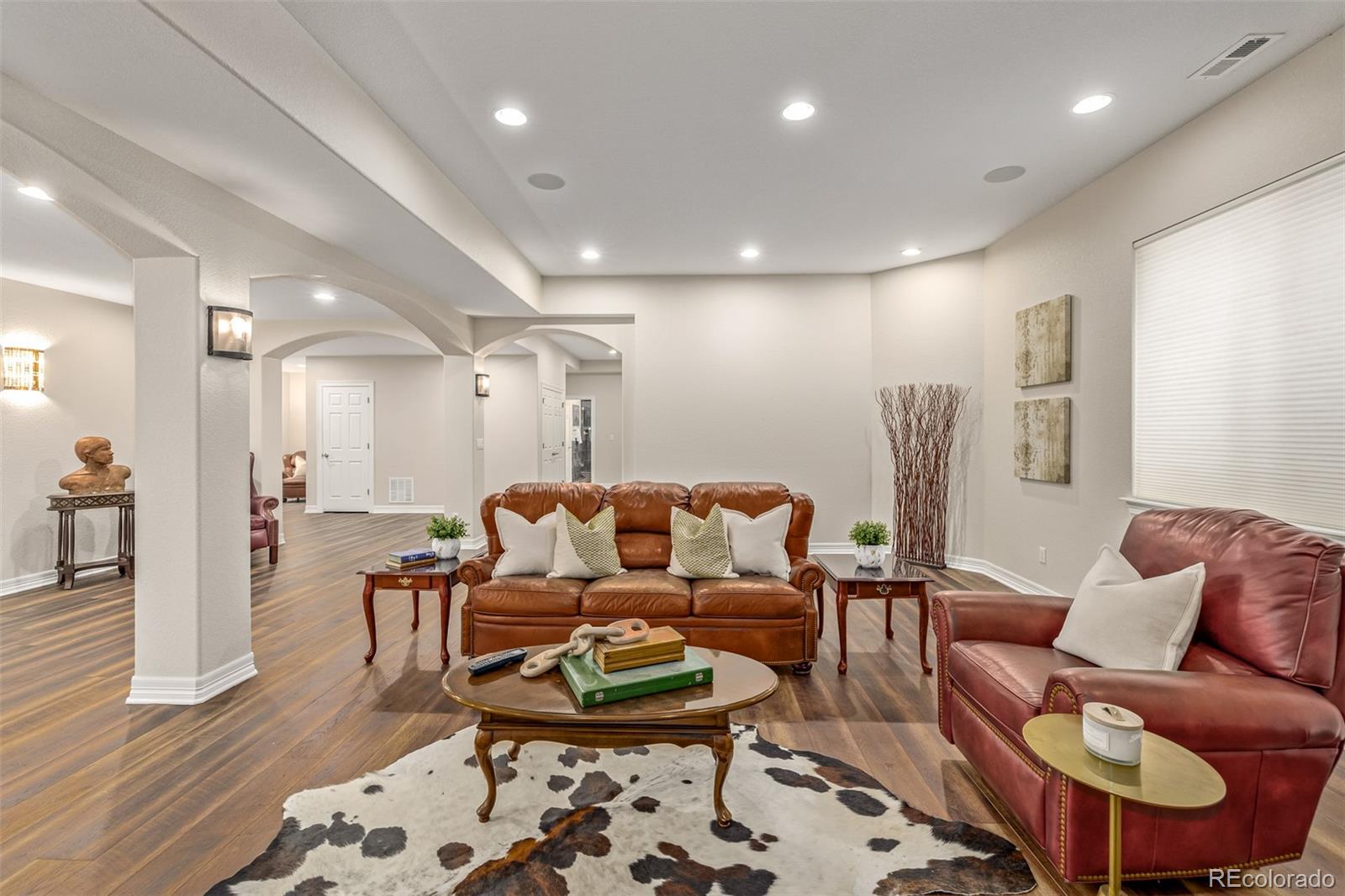 20166 East Shady Ridge Road Parker, CO 80134 - Photo 33 of 50 a living room with furniture and a wooden floor