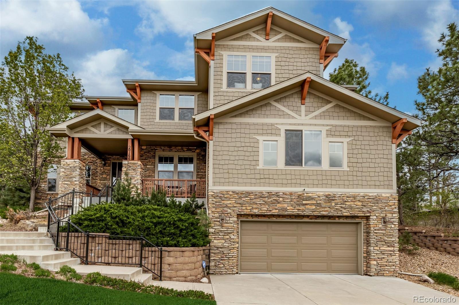 20166 East Shady Ridge Road Parker, CO 80134 - Photo 4 of 50 a front view of a house with a yard and garage