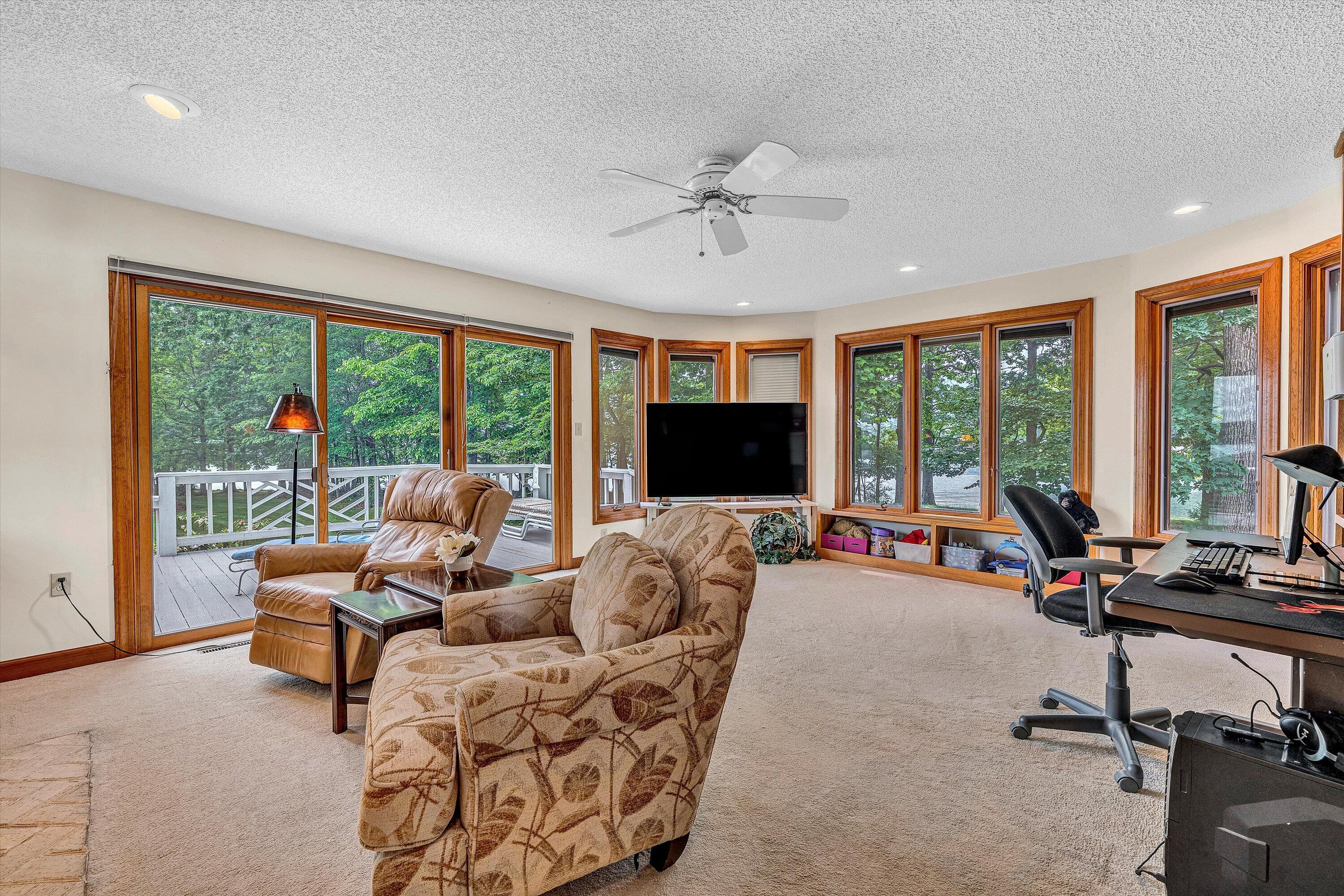 217 Anthony Home Road Huddleston, VA 24104 - Photo 11 of 68 a living room with furniture tv and large windows
