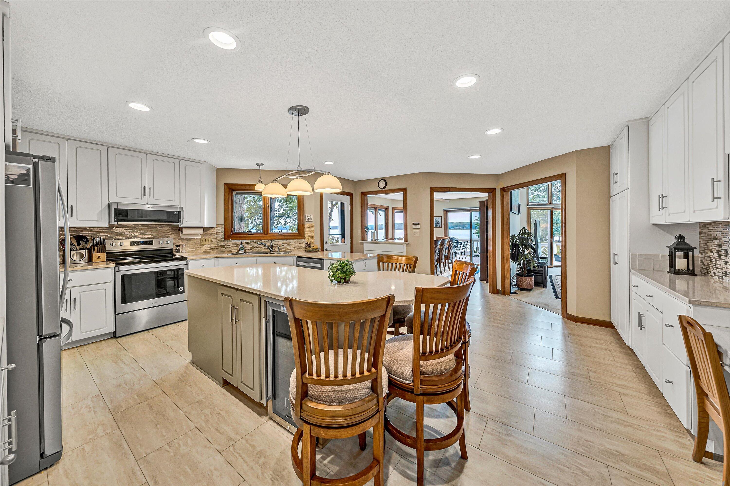 217 Anthony Home Road Huddleston, VA 24104 - Photo 17 of 68 a kitchen with stainless steel appliances granite countertop a stove top oven a sink dishwasher a dining table and chairs with wooden floor