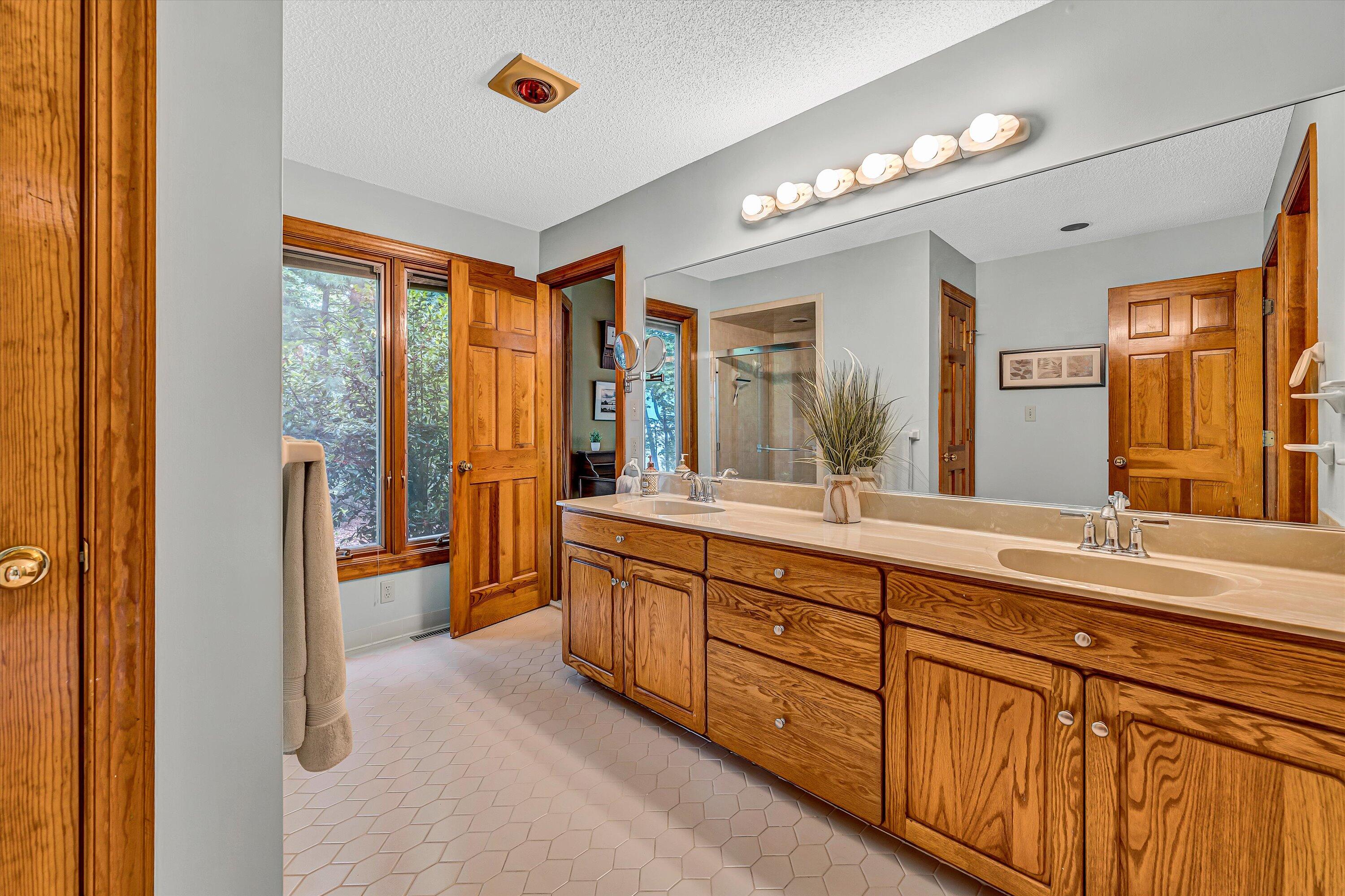 217 Anthony Home Road Huddleston, VA 24104 - Photo 28 of 68 a spacious bathroom with a granite countertop sink mirror and a shower