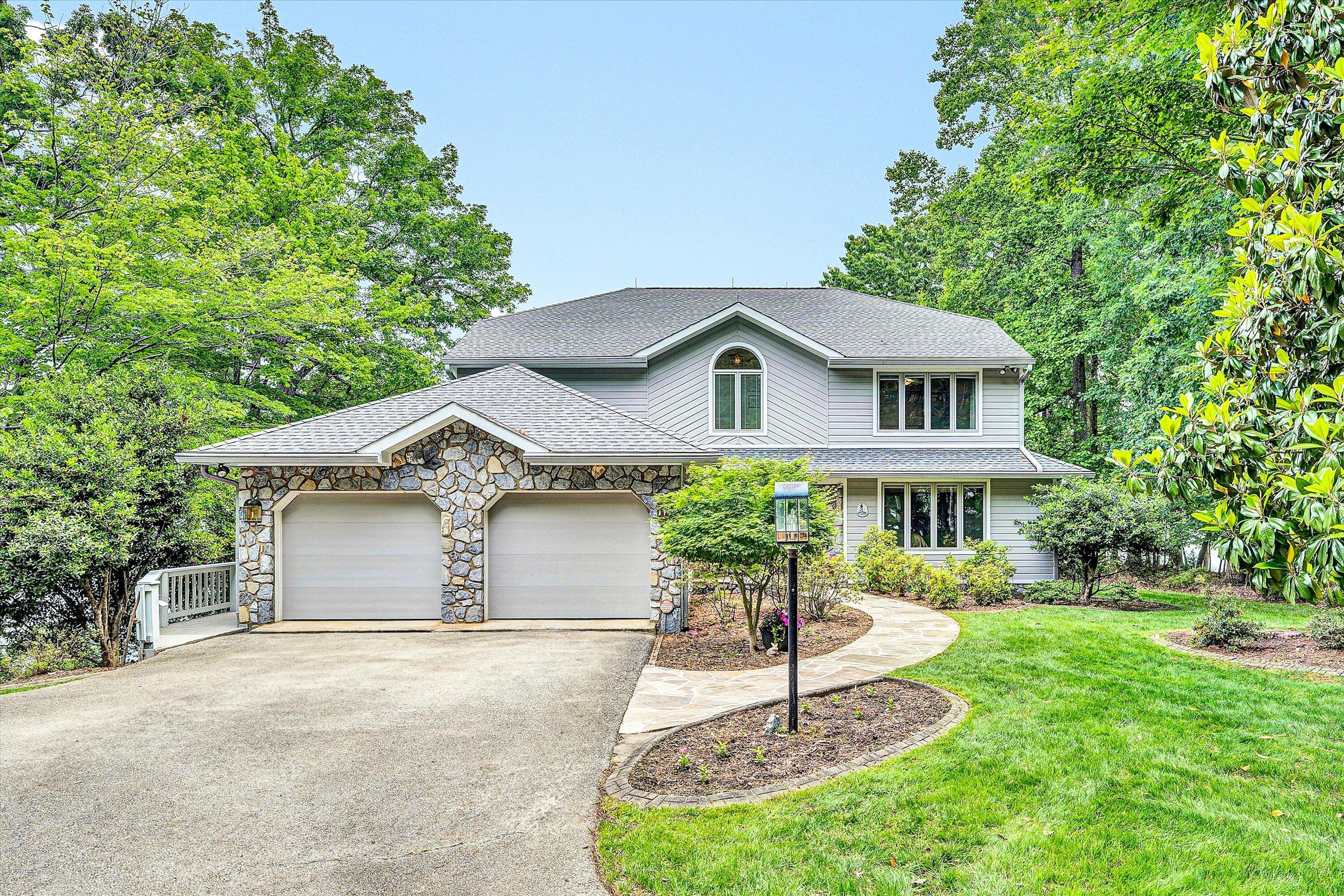 217 Anthony Home Road Huddleston, VA 24104 - Photo 3 of 68 a front view of a house with a yard and garage