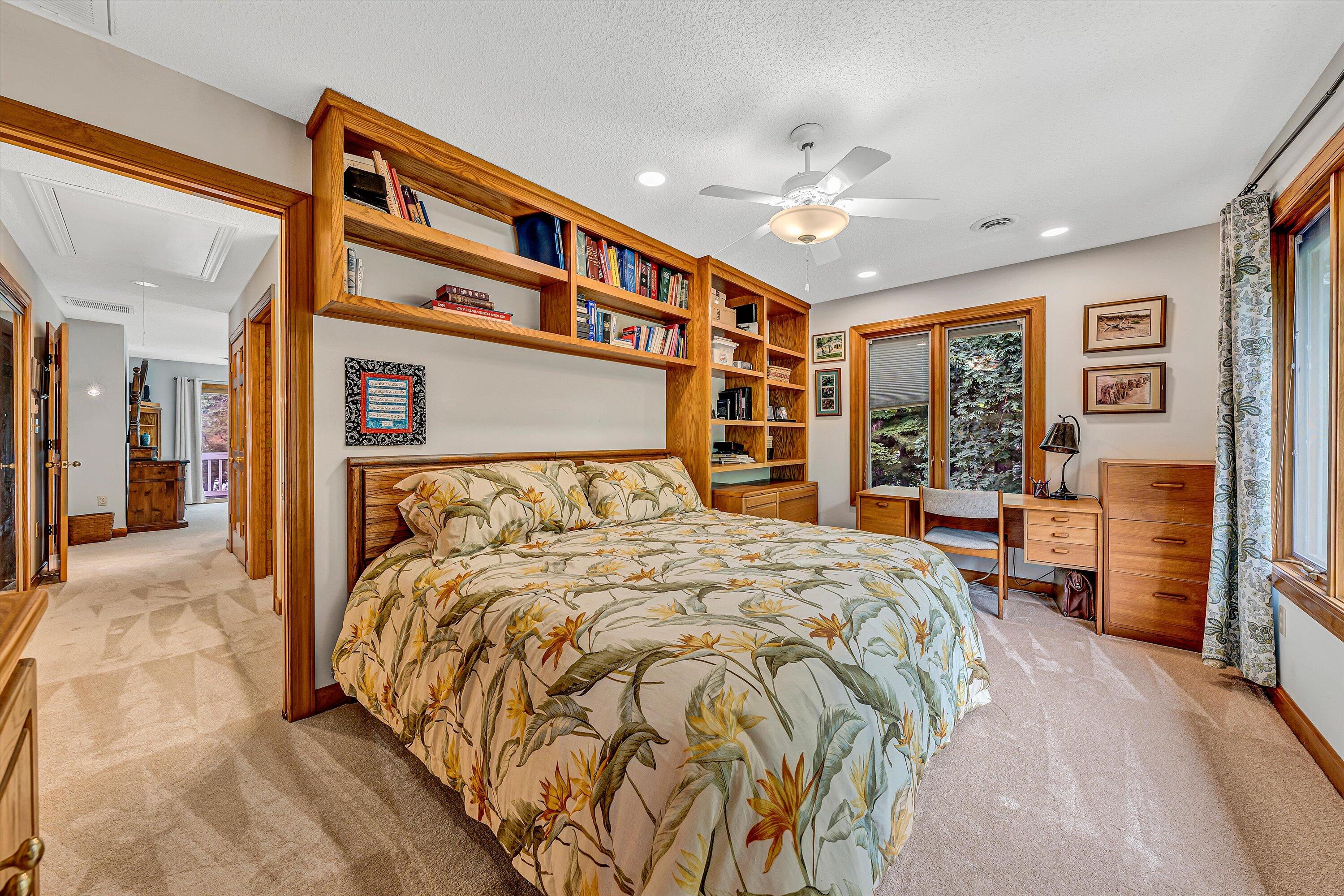 217 Anthony Home Road Huddleston, VA 24104 - Photo 37 of 68 a bedroom with a large bed and a chandelier