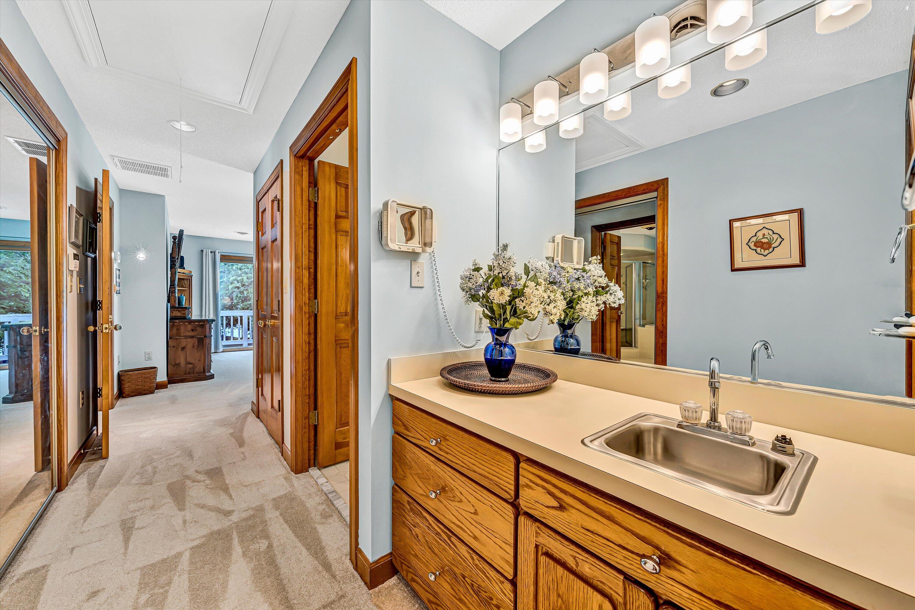 217 Anthony Home Road Huddleston, VA 24104 - Photo 38 of 68 a bathroom with a granite countertop sink a large mirror and a shower