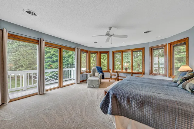a view of a roof deck with table and chairs a barbeque with wooden floor and fence