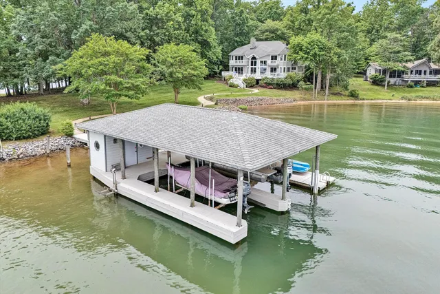 an aerial view of a house with swimming pool having outdoor seating