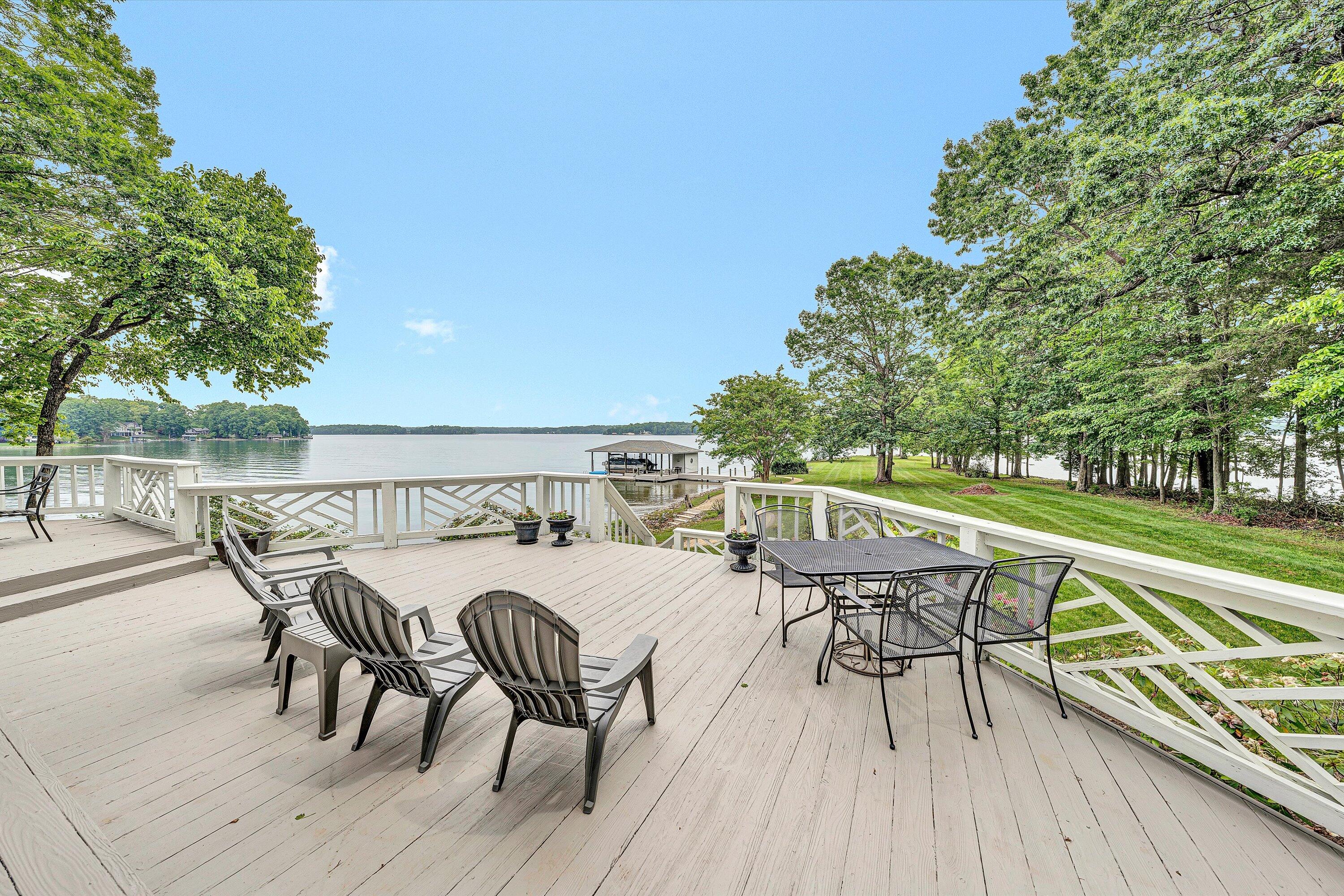217 Anthony Home Road Huddleston, VA 24104 - Photo 52 of 68 a view of a roof deck with table and chairs a barbeque with wooden floor and fence
