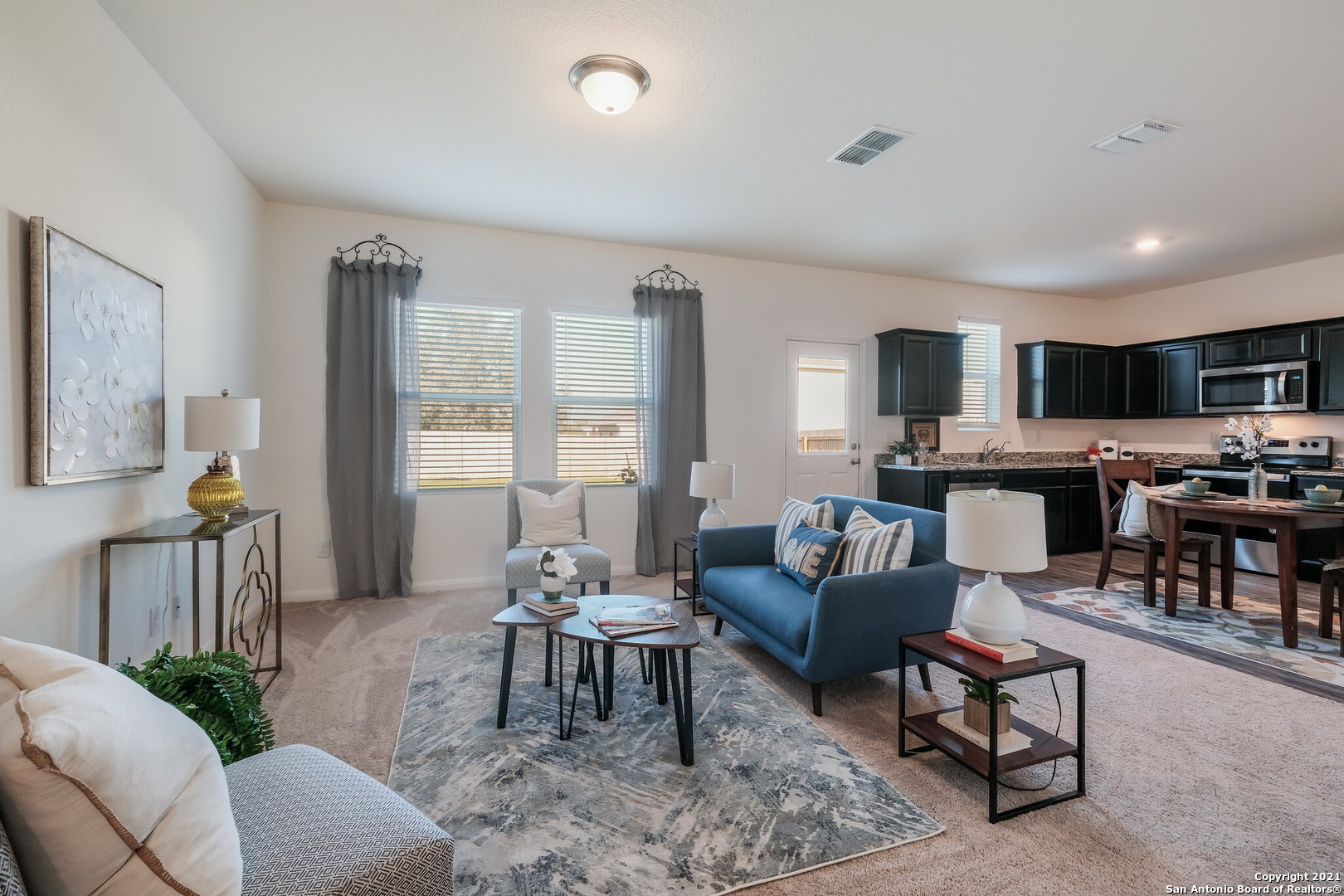 a living room with furniture and kitchen view