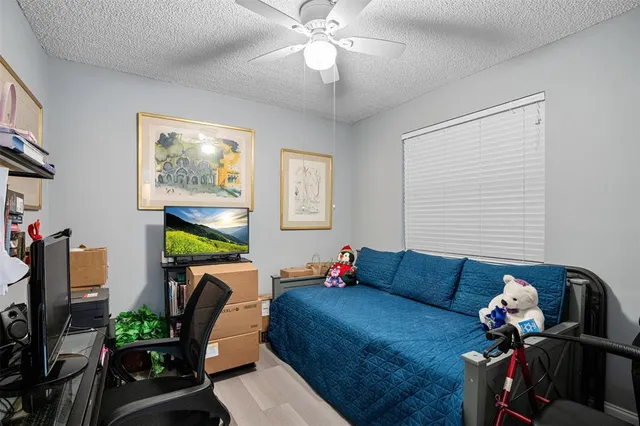 a living room with furniture flowerpot and a chandelier
