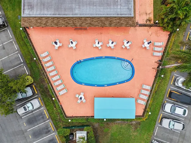 an aerial view of a residential houses with outdoor space and swimming pool