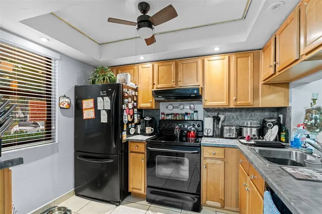 a kitchen with stainless steel appliances granite countertop a refrigerator stove top oven a sink and dishwasher