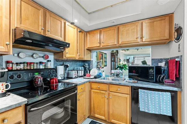 a kitchen with stainless steel appliances granite countertop a sink dishwasher stove and cabinets