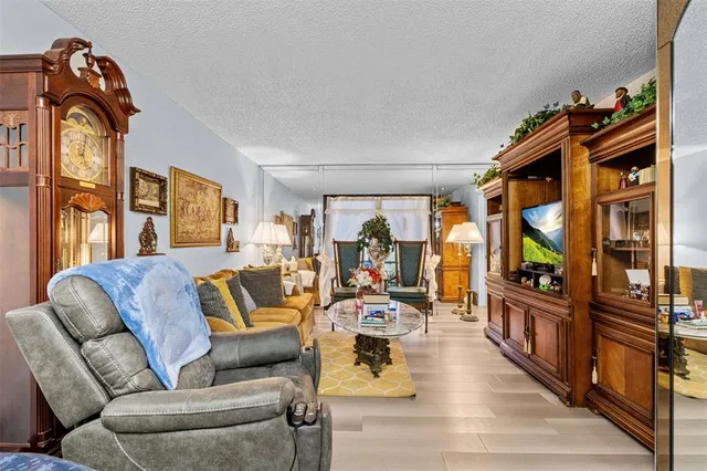 a living room with furniture ceiling fan and a rug