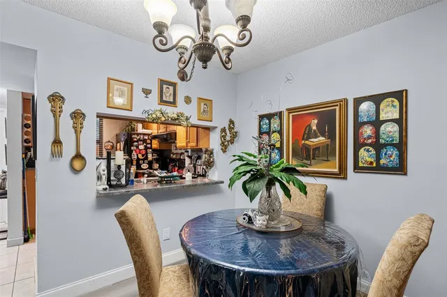 a view of a dining room with furniture wooden floor and chandelier