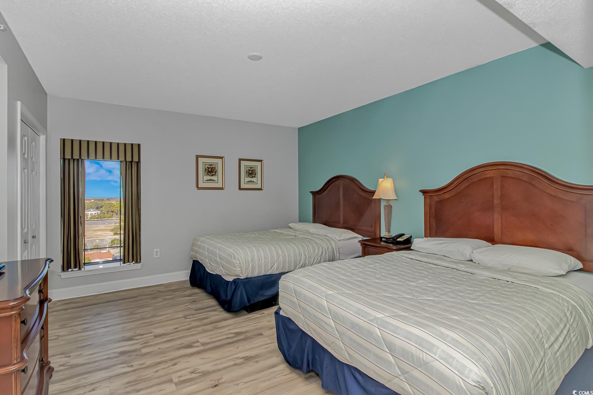 2600 North Ocean Boulevard, Unit 1715 Myrtle Beach, SC 29577 - Photo 16 of 34 Bedroom with light wood-style flooring and baseboards