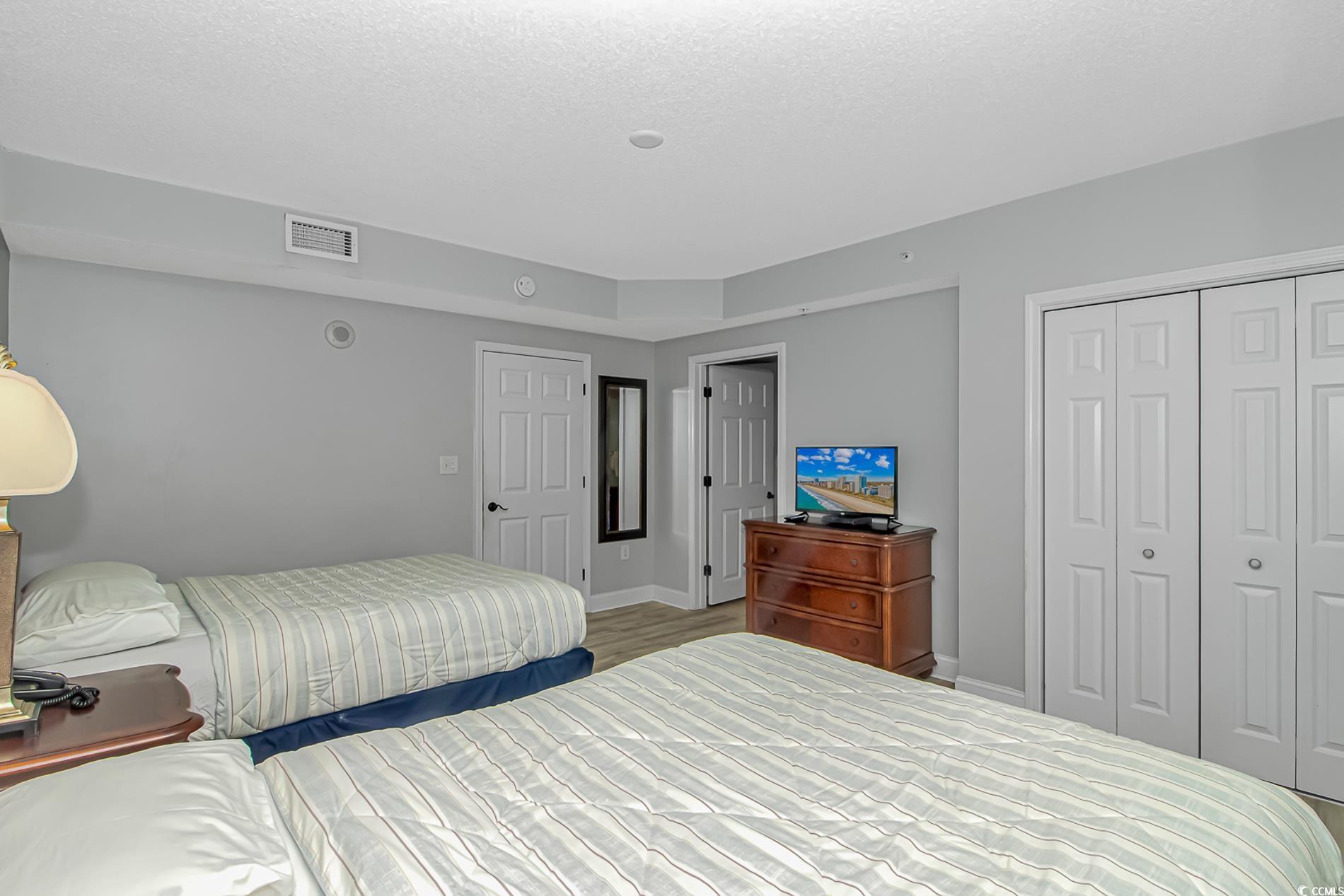 2600 North Ocean Boulevard, Unit 1715 Myrtle Beach, SC 29577 - Photo 17 of 34 Bedroom with a closet and a textured ceiling