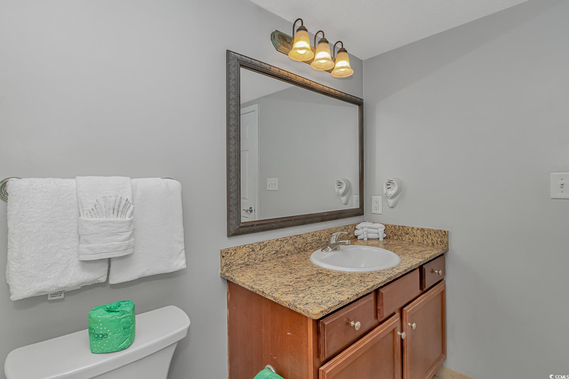 2600 North Ocean Boulevard, Unit 1715 Myrtle Beach, SC 29577 - Photo 19 of 34 Half bathroom featuring vanity and toilet