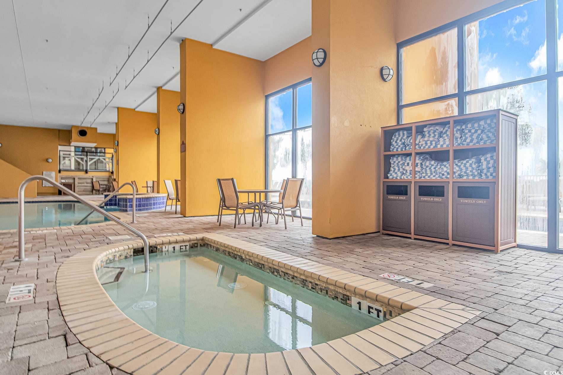2600 North Ocean Boulevard, Unit 1715 Myrtle Beach, SC 29577 - Photo 22 of 34 View of pool featuring a swimming pool, a hot tub, a patio, and a sunroom