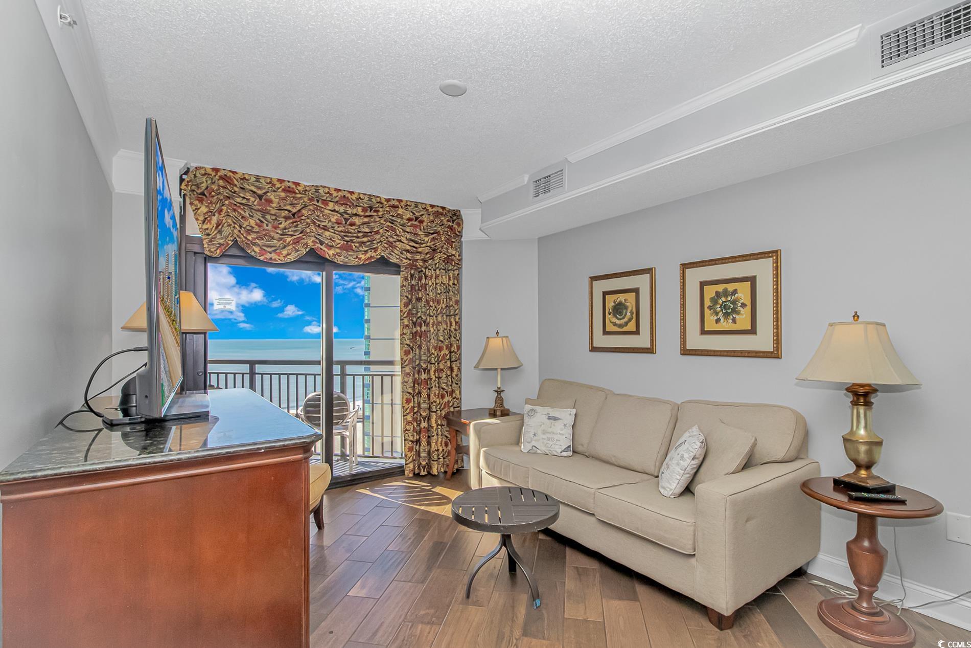 2600 North Ocean Boulevard, Unit 1715 Myrtle Beach, SC 29577 - Photo 6 of 34 Living room with hardwood / wood-style flooring and a textured ceiling