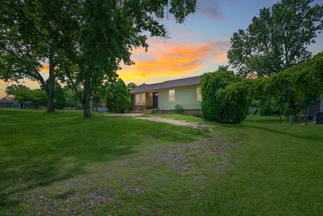 a view of house with backyard