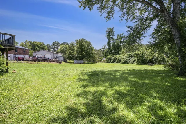 a view of a green field with sitting area