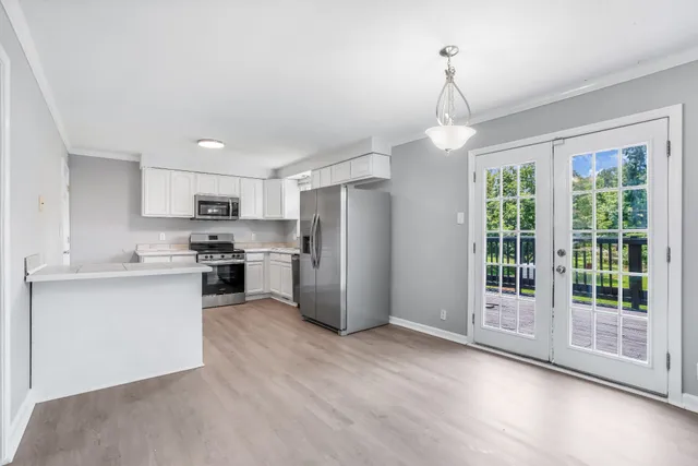a kitchen with a refrigerator and a sink